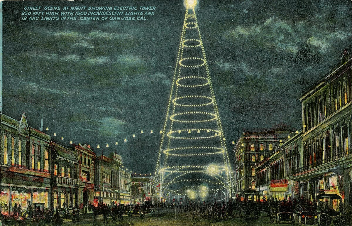 The electric light tower over Market and Santa Clara streets at night, in an early postcard